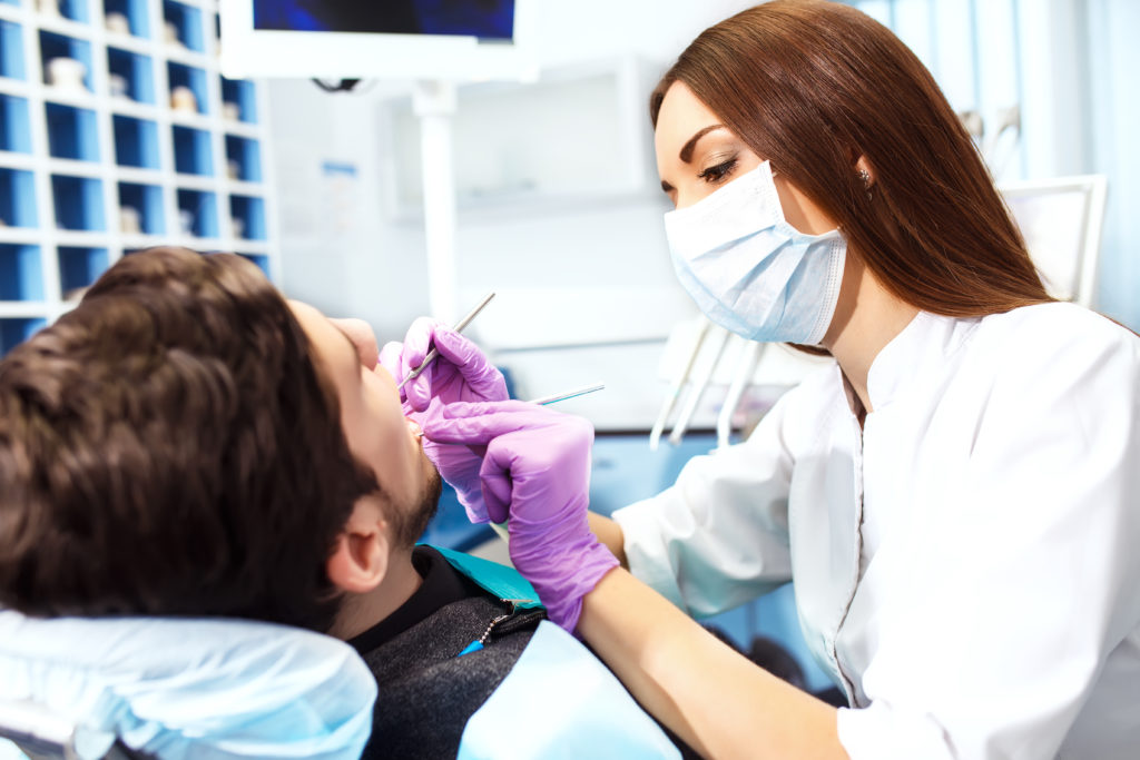 Female dentist and male patient