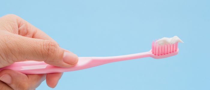 Close-up of a person holding a toothbrush