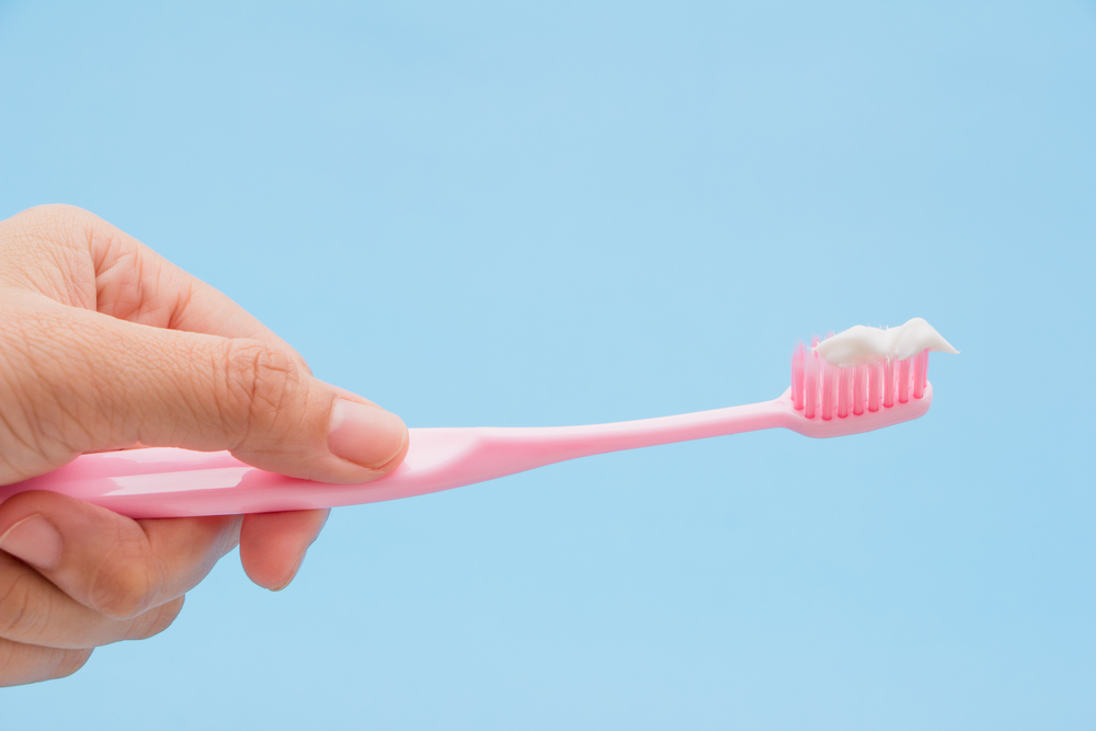 Close-up of a person holding a toothbrush